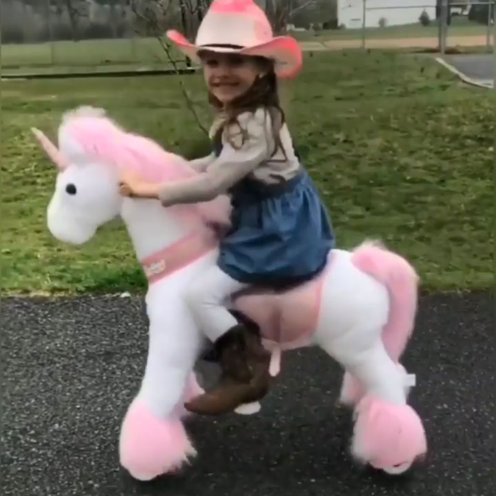 Cow girl with her ride-on unicorn