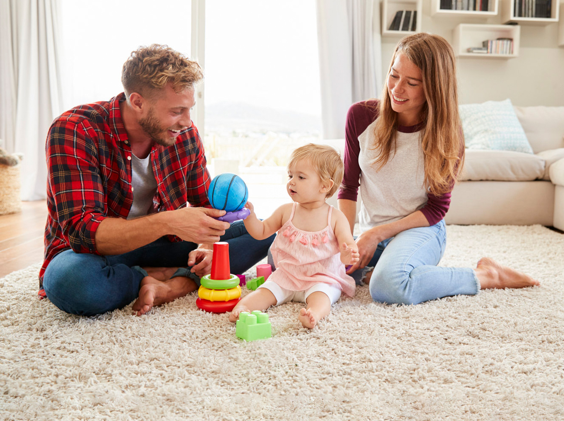 parents playing toys with child