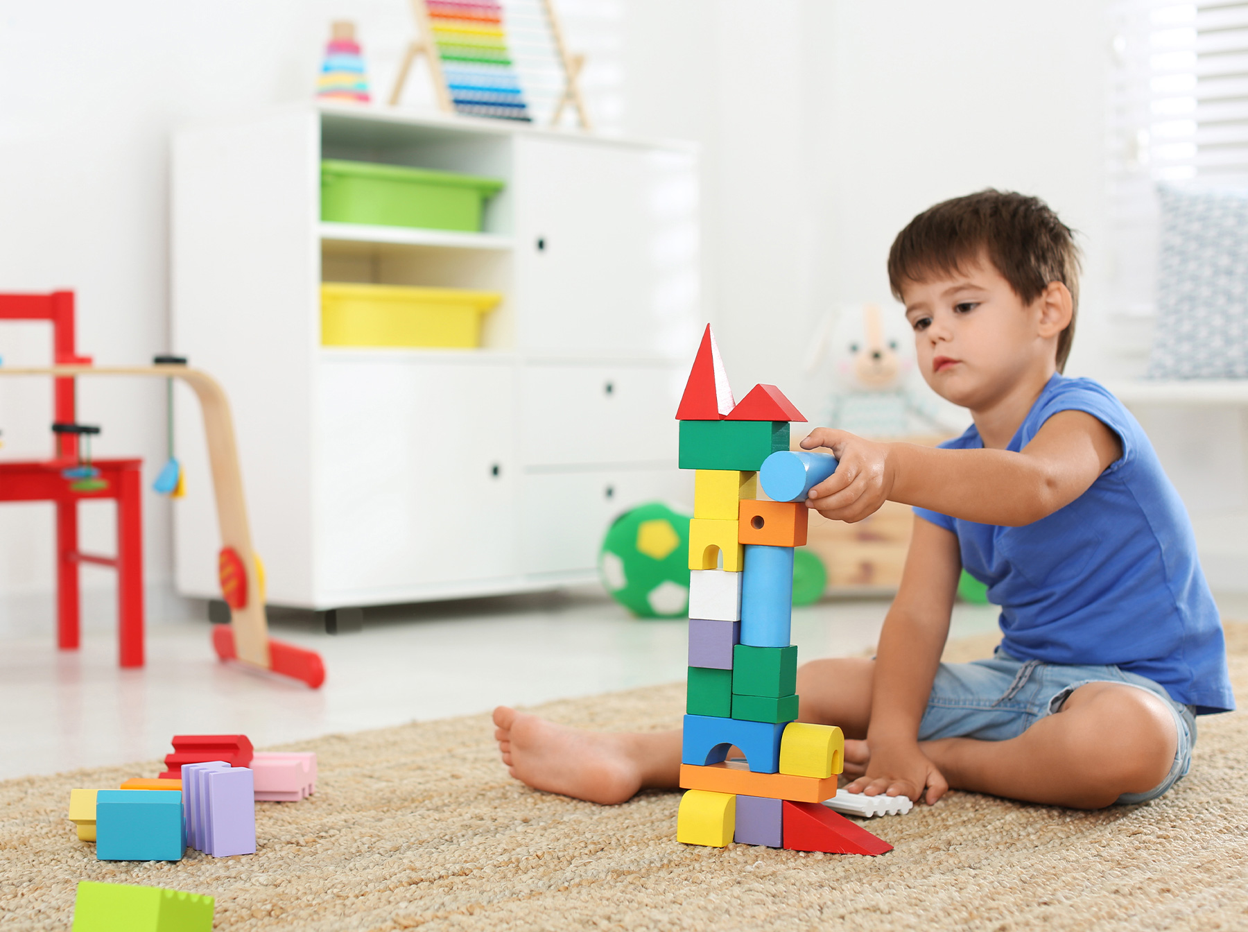 toddler building large blocks tower castle
