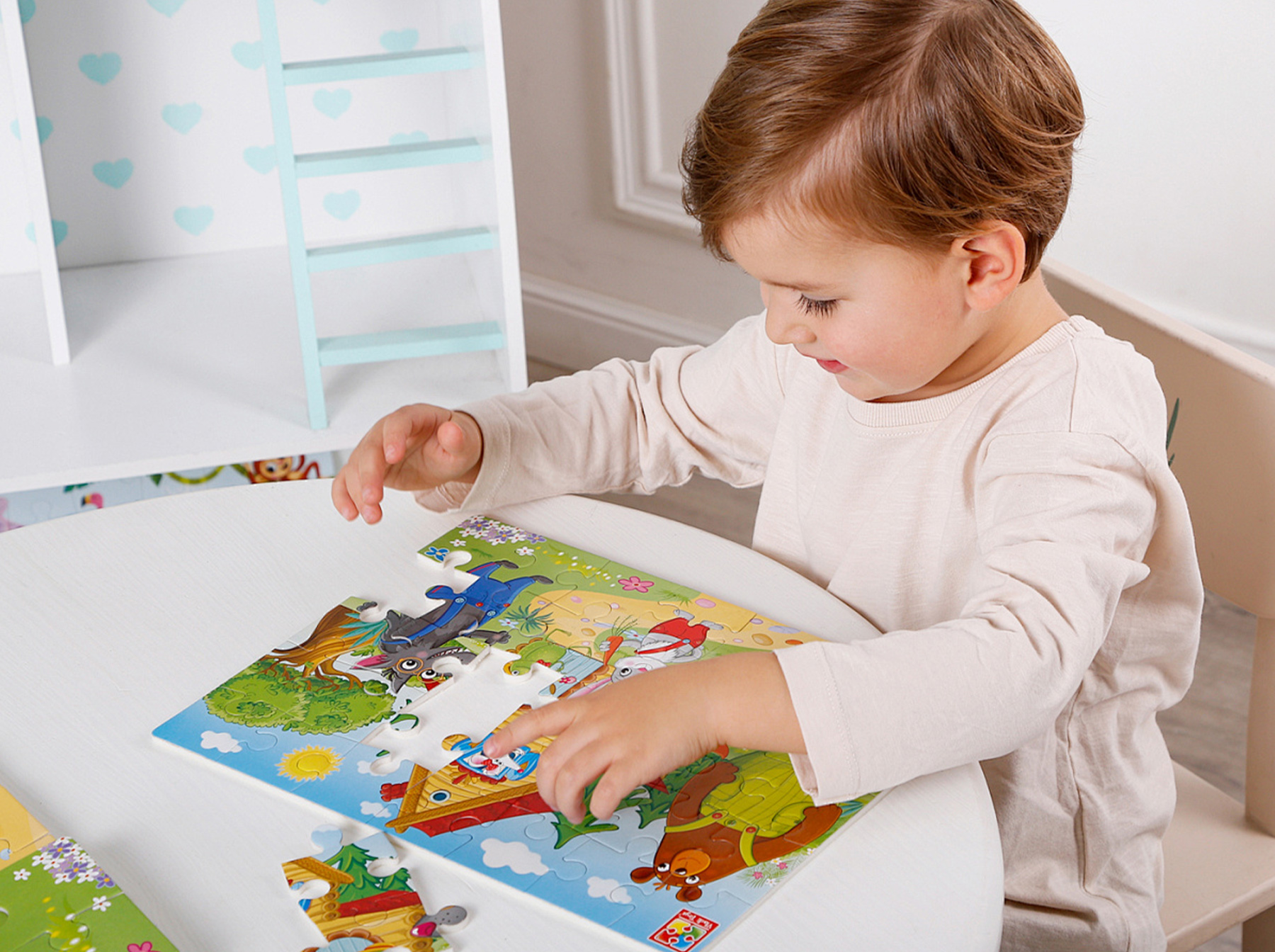toddler completing dinosaur puzzle pieces