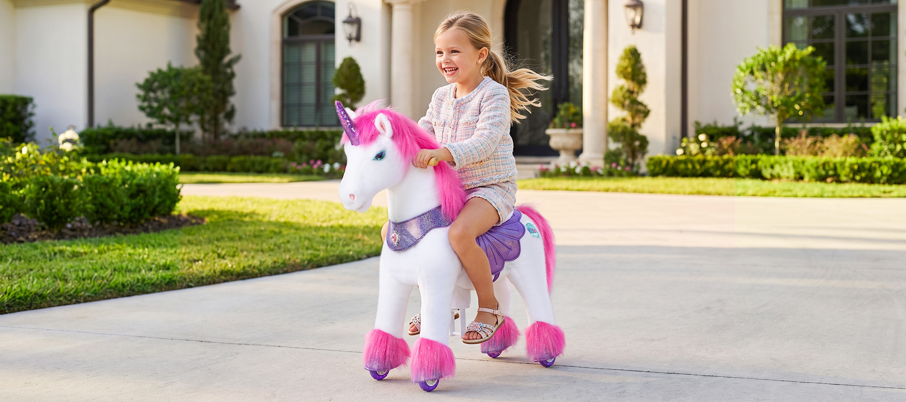 ride-on-unicorn-toy-moving-forward-lawn child riding a ride-on horse toy down a hallway at home